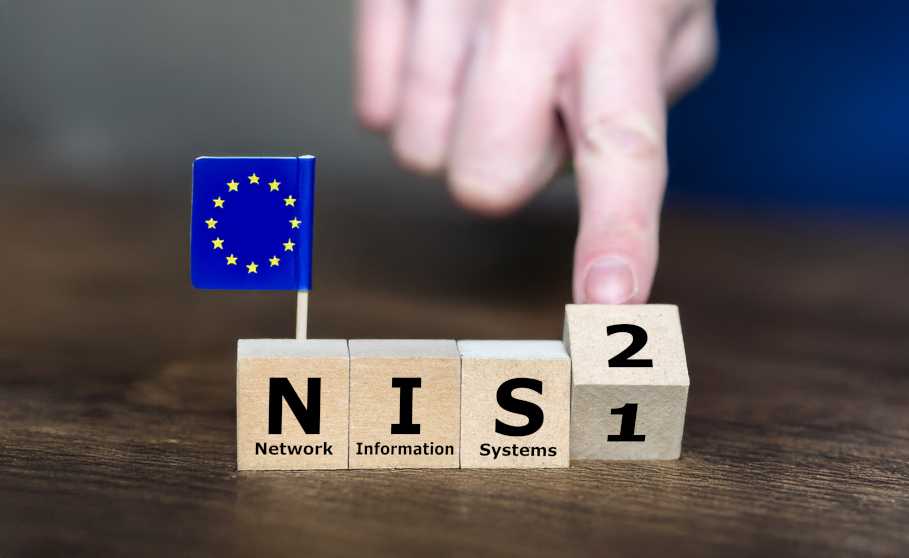 Four small wooden cubes on which the 4 characters NIS2 are printed and a small European flag